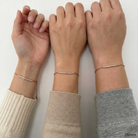 Thumbnail for Three wrists side by side wearing the rose gold Crystal Bar Bracelet, size reference shown