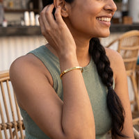 Thumbnail for Woman gently touching her Carpe Diem bracelet in gold | SKU: cp-g