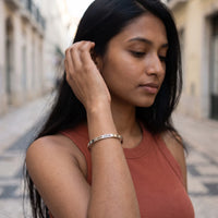 Thumbnail for Woman gently touching her Carpe Diem bracelet in silver | SKU: cp-wg
