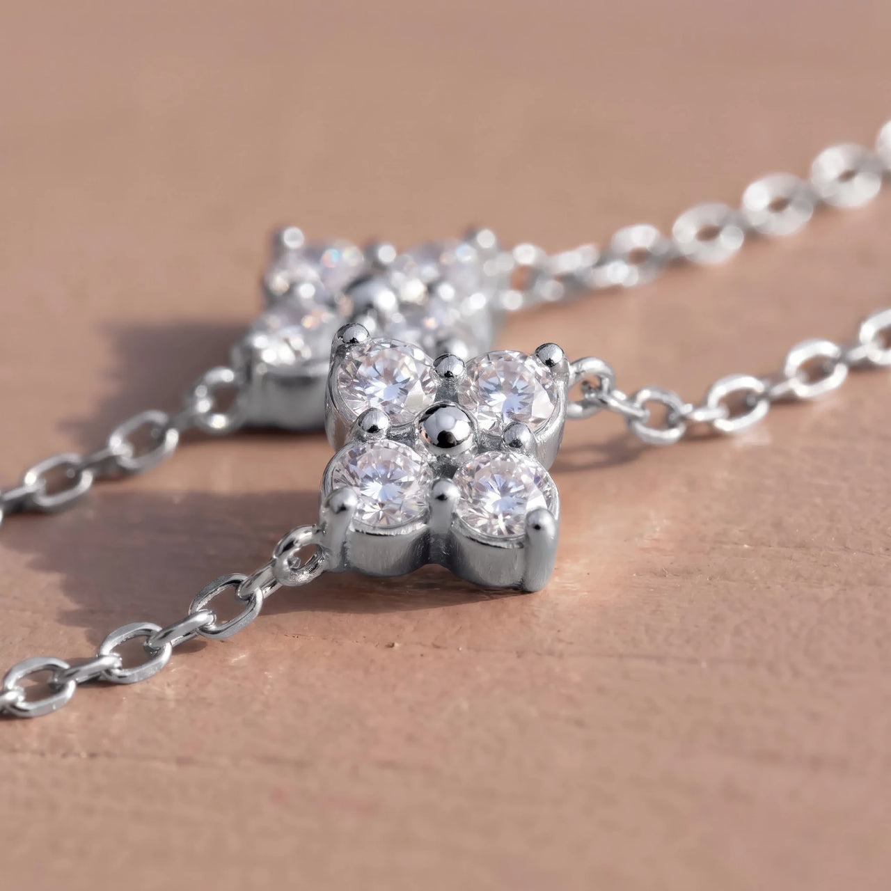 Clover Charm Anklet in Silver close-up of the clover charm