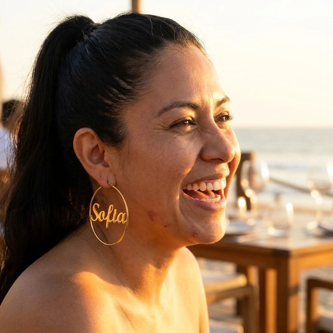 Custom Name Hoop Earrings in Gold worn outdoors, lifestyle shot | SKU: name-hoop-gold-30-mm