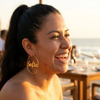 Thumbnail for Custom Name Hoop Earrings in Gold worn outdoors, lifestyle shot | SKU: name-hoop-gold-30-mm