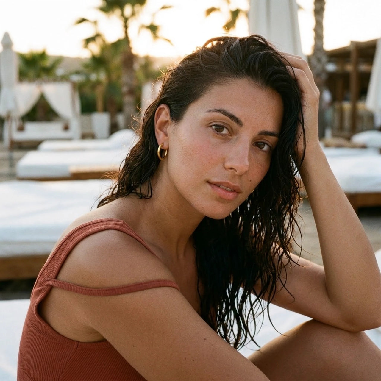 Everyday Waterproof Hoops in Gold, worn at a beach club at sunset | SKU: 41001-gold