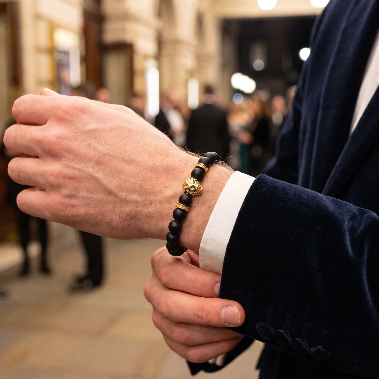 Gold Lion & Black Stones Bracelet – worn with a shirt cuff | Brother & Sisters | SKU: 20712286-gold-XS-14-15, 20712286-gold-S-16-17, 20712286-gold-M-18-19, 20712286-gold-L-20-21, 20712286-gold-XL-22-23