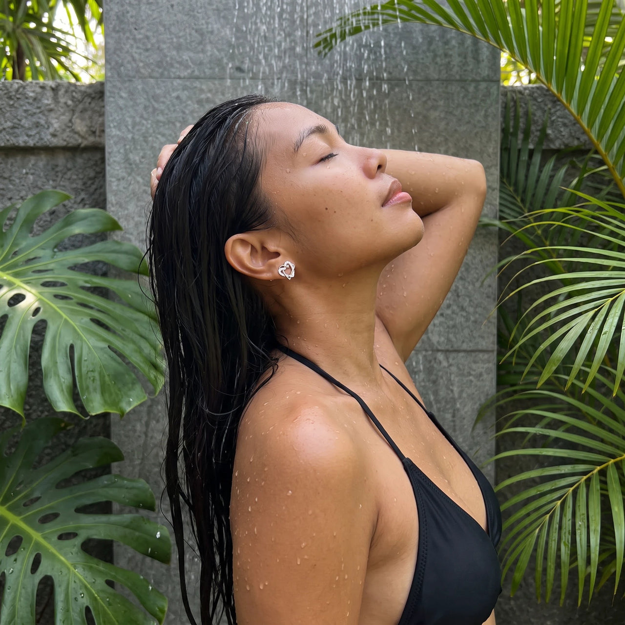 Silver stud earrings worn in a tropical outdoor shower | SKU: 4478648-platinum-plated-clear