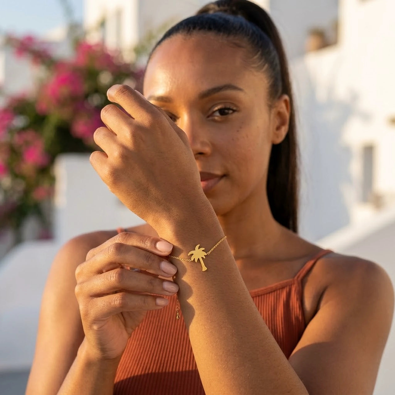 Woman gently touching her gold charm bracelet | SKU: 7819407-gold-color