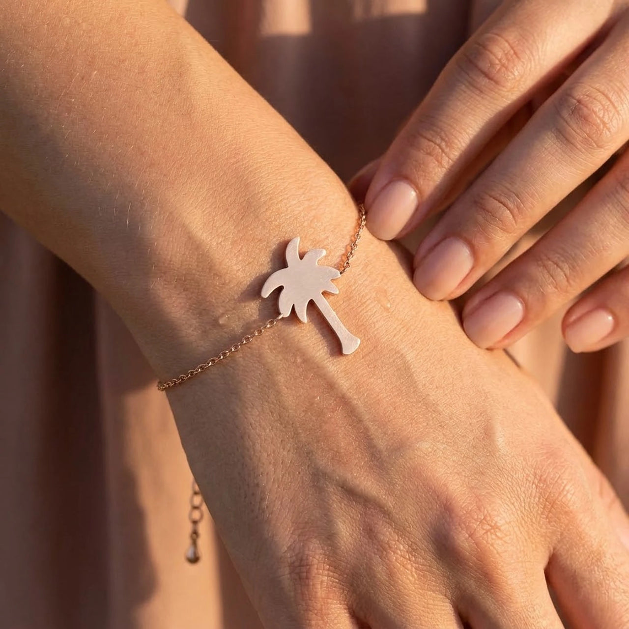 Close-up of the rose gold charm bracelet worn on the skin | SKU: 7819407-rose-gold-color