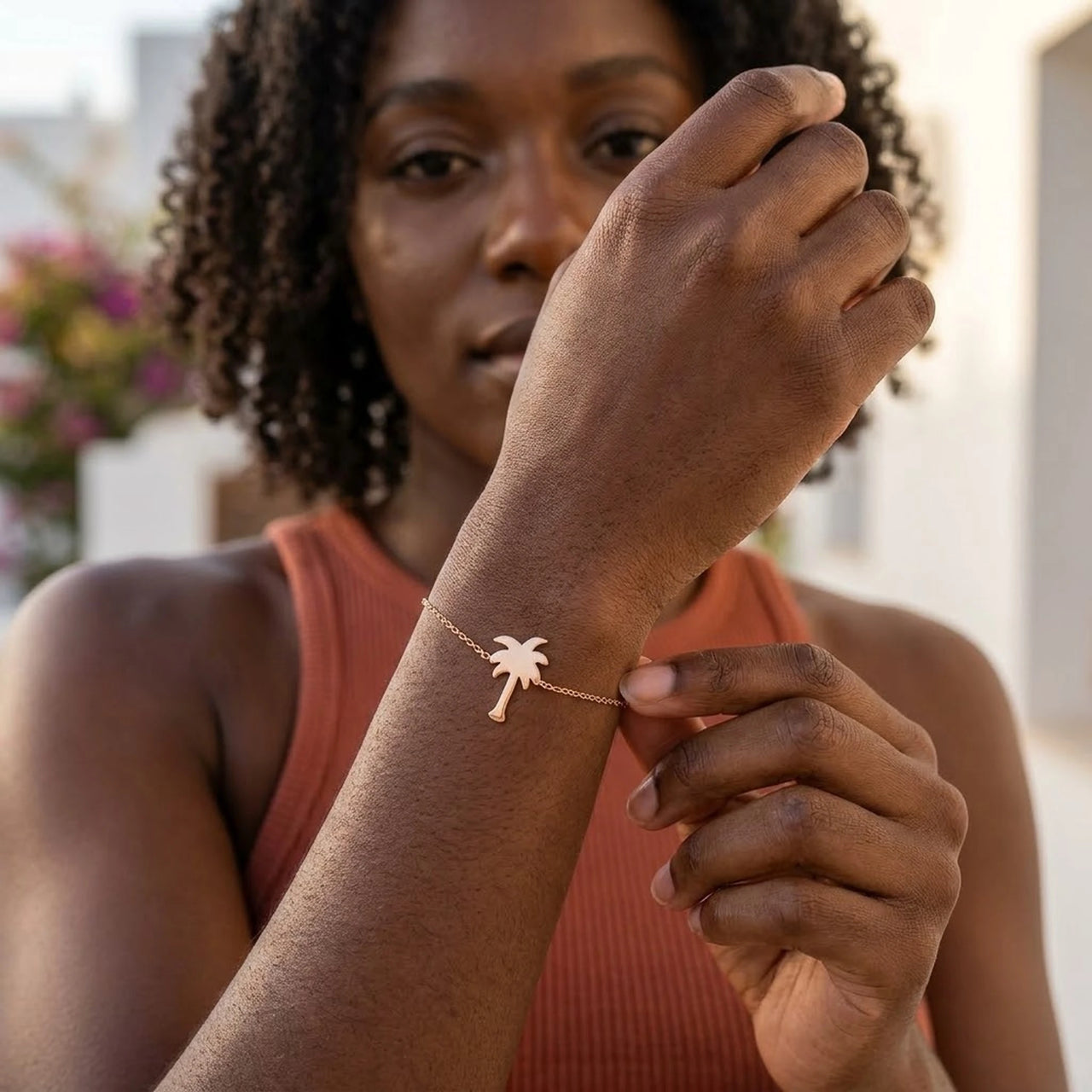 Woman gently touching her rose gold charm bracelet | SKU: 7819407-rose-gold-color