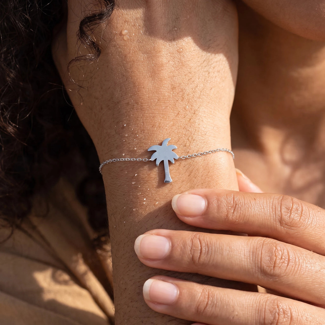 Close-up of the silver charm bracelet worn on the skin | SKU: 7819407-silver-plated