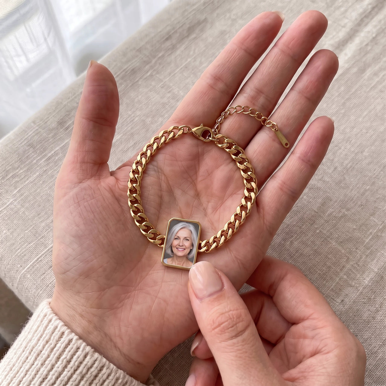 The gold cushion-cut photo bracelet in her palm, a fingertip warming the charm to reveal her mother's photo | SKU: TPH-CUSB-GOLD