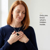 Thumbnail for Woman holding the black silver heart pendant to her chest, only she knows the photo inside | SKU: TPH-HRTN-SILVER
