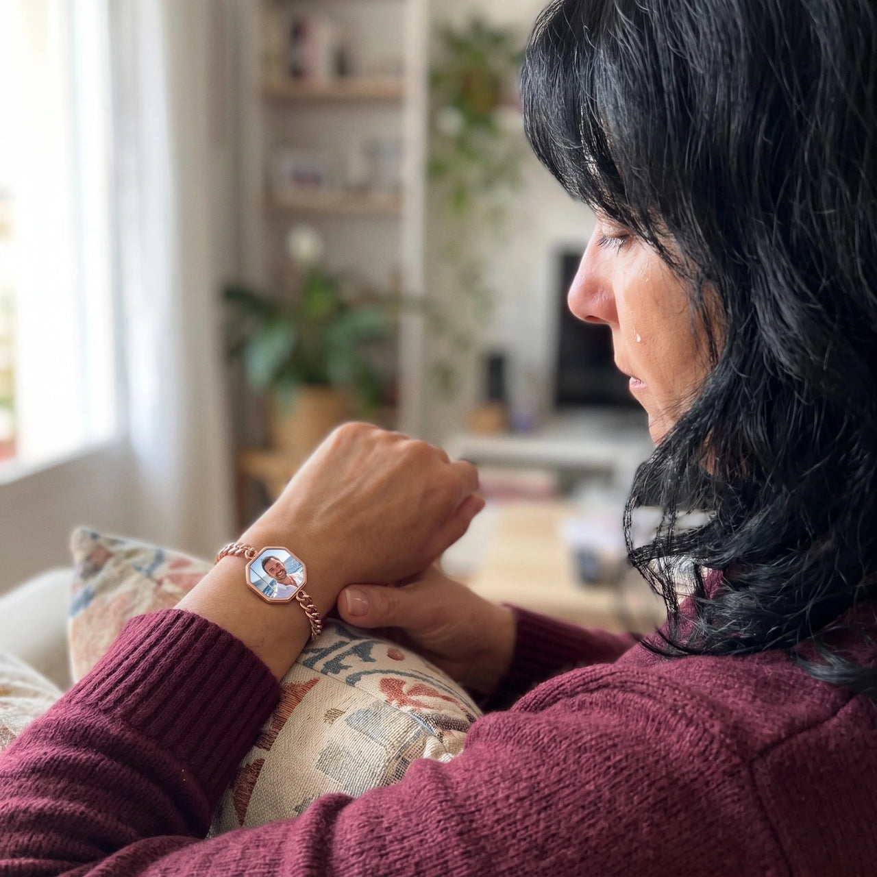Woman looking at her husband's photo in the rose gold octagon photo bracelet | SKU: TPH-OCTB-ROSEGOLD-18