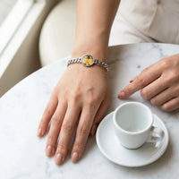 Thumbnail for The silver round photo bracelet on her wrist at a cafe table, showing its real small size | SKU: TPH-RNDB-SILVER
