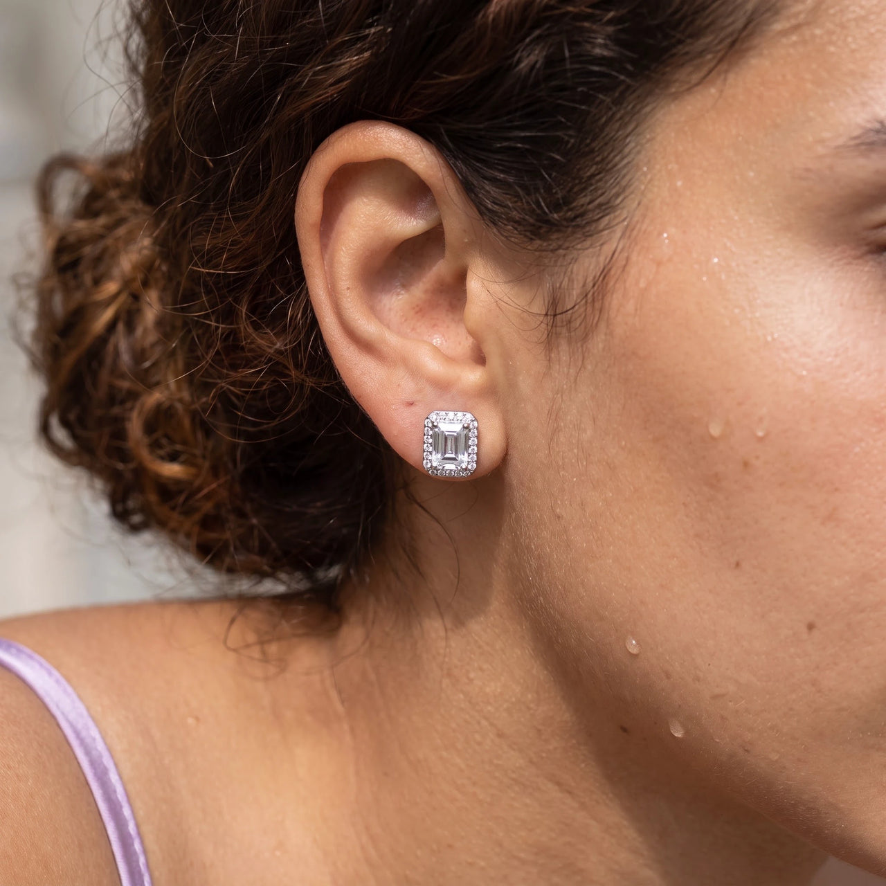 Close-up of the silver stud earrings worn on the skin | SKU: 22683128